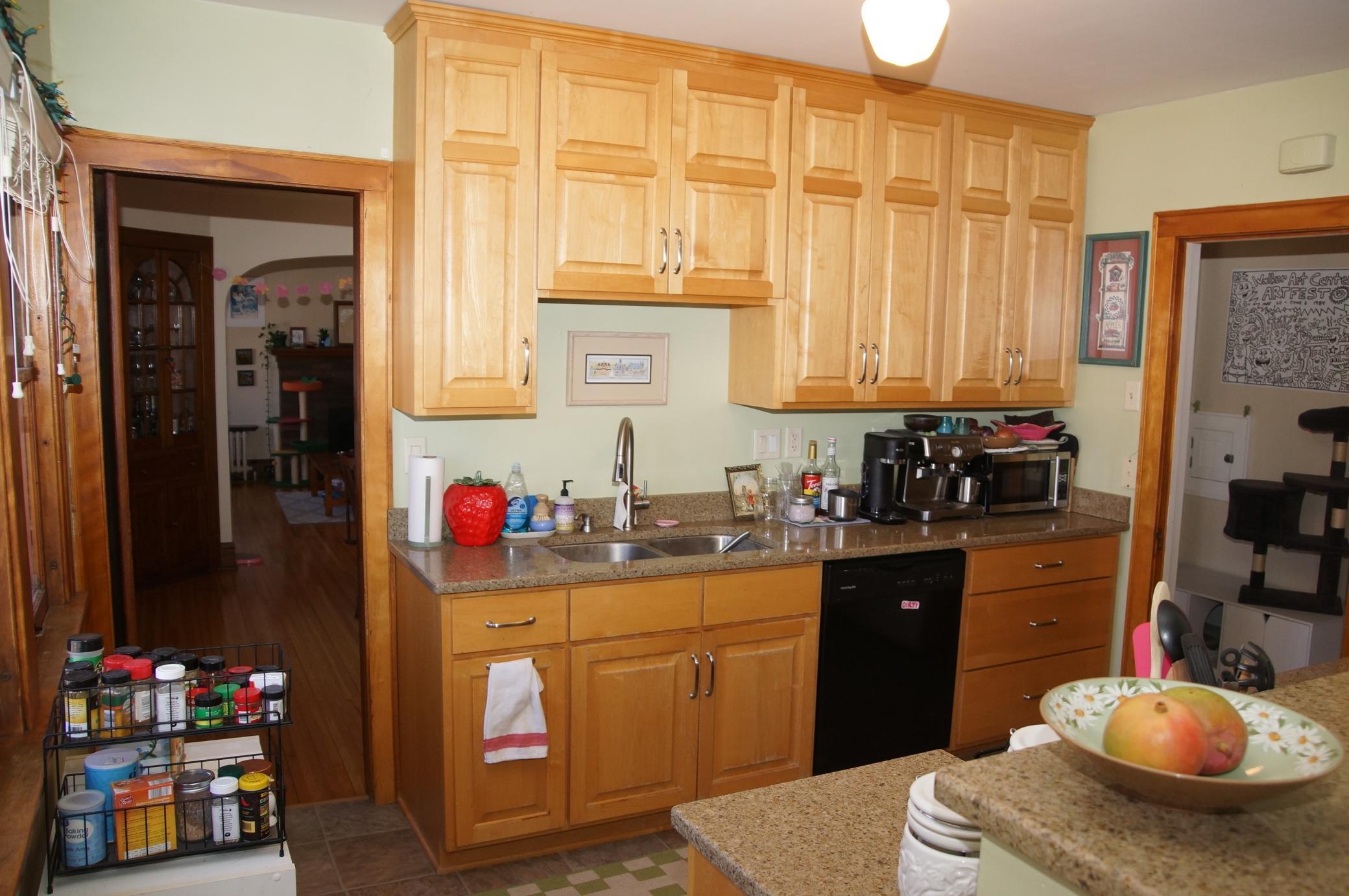 Updated Kitchen Sports Maple Cabinetry and Quartz Counters!