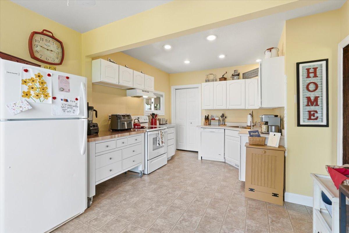 The adorable, bright kitchen welcomes you from the back entry!
