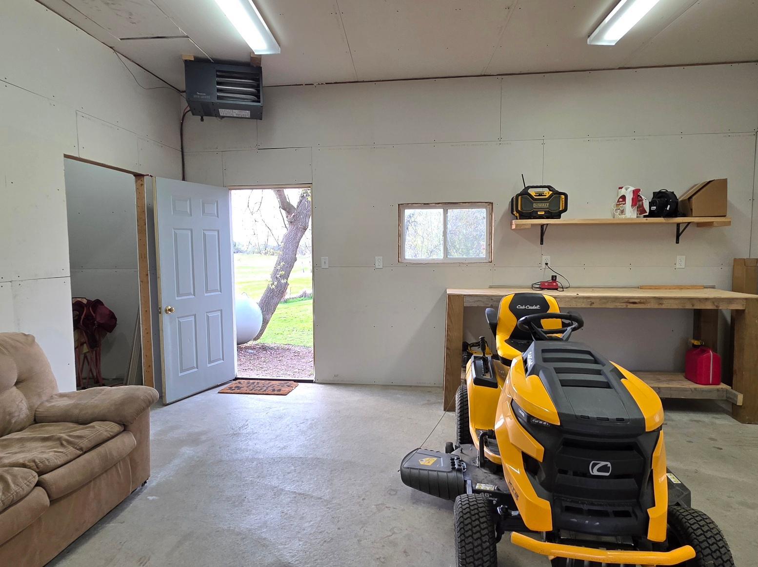 Heated third garage space with storage room and easy access to backyard