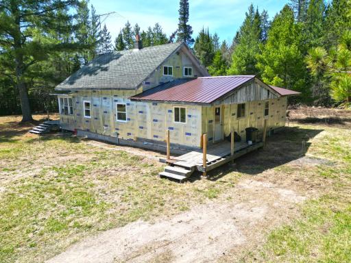 This nearly century old farm house features some original rough sawn wood and log beams