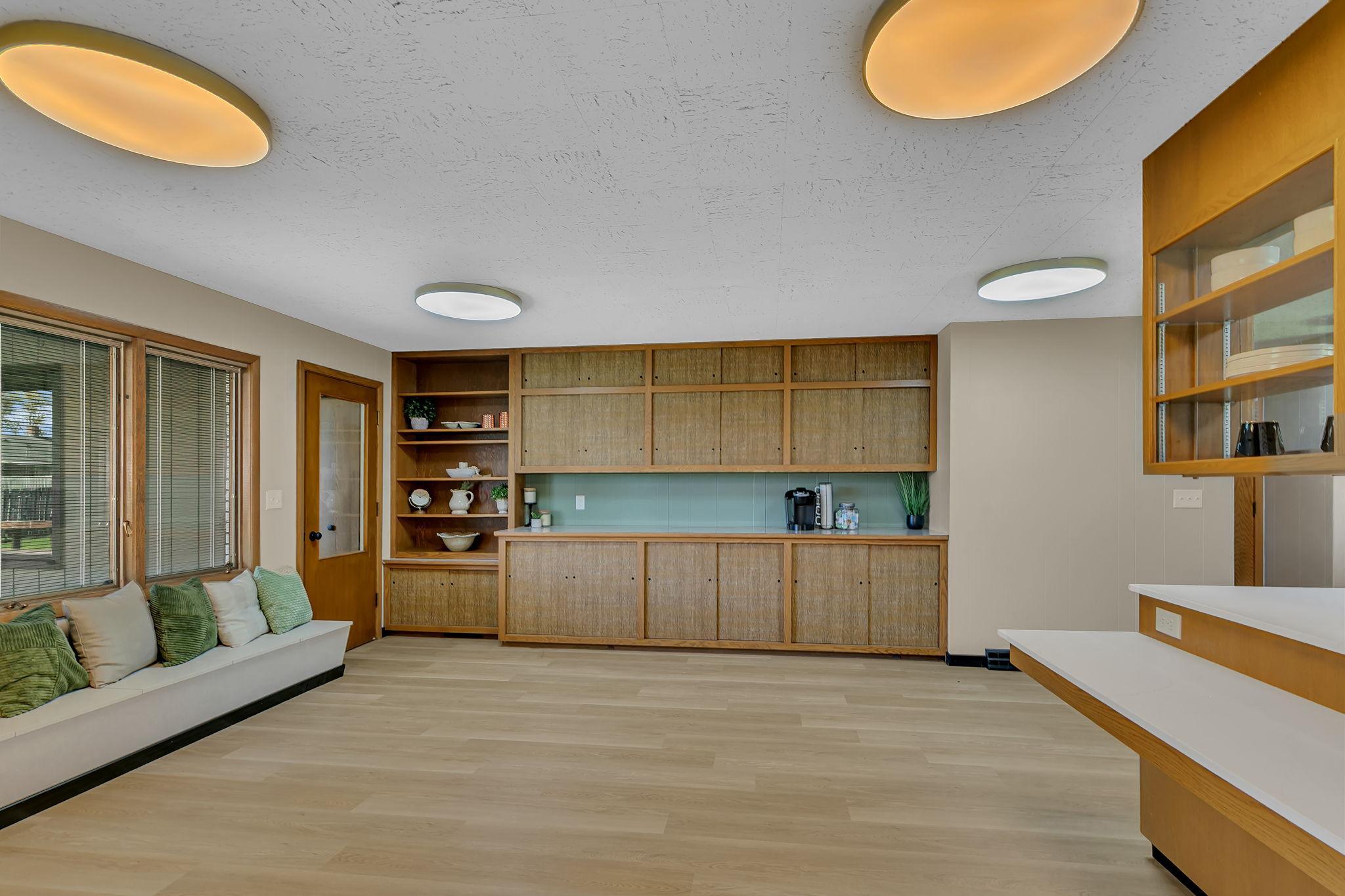 Door lends access to owners suite and hallway to deck. Storage visable here includes the cabinetry and the bench seating that opens as well.