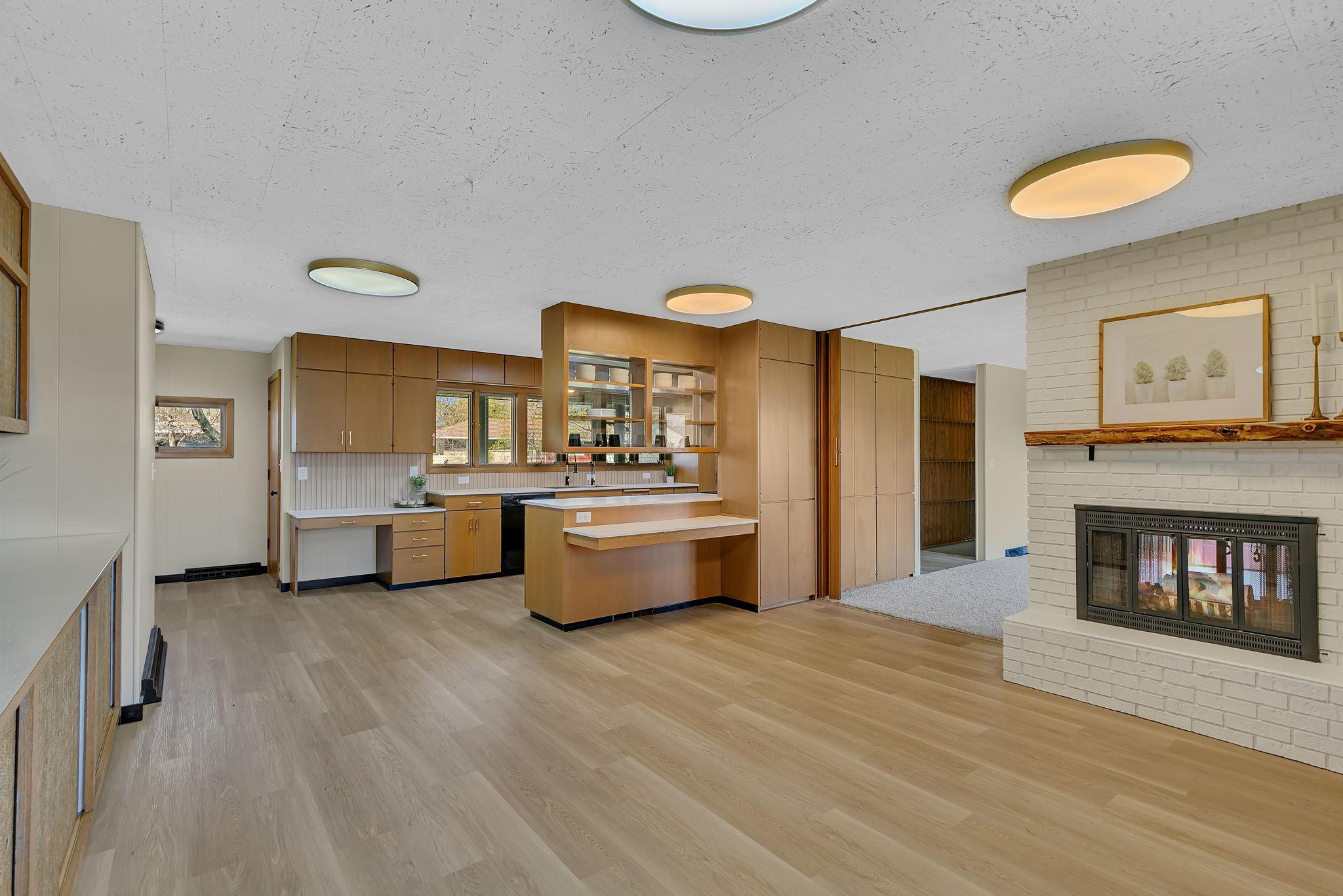 Updates throughout the home include flooring, lighting, and paint. Note the floor to ceiling storage that allows for living room access as well.