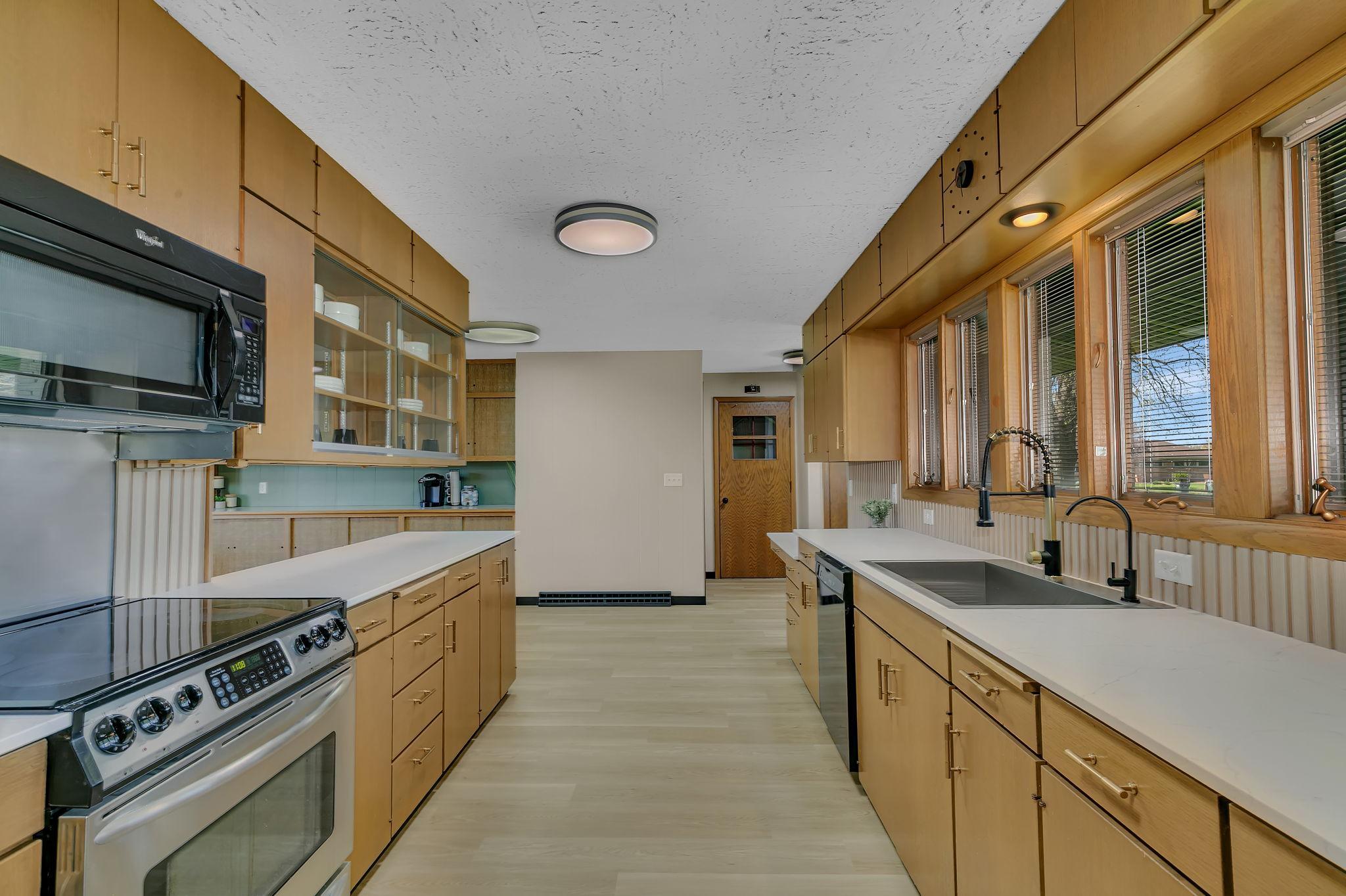 Open kitchen layout flows seamlessly into dining and living areas.