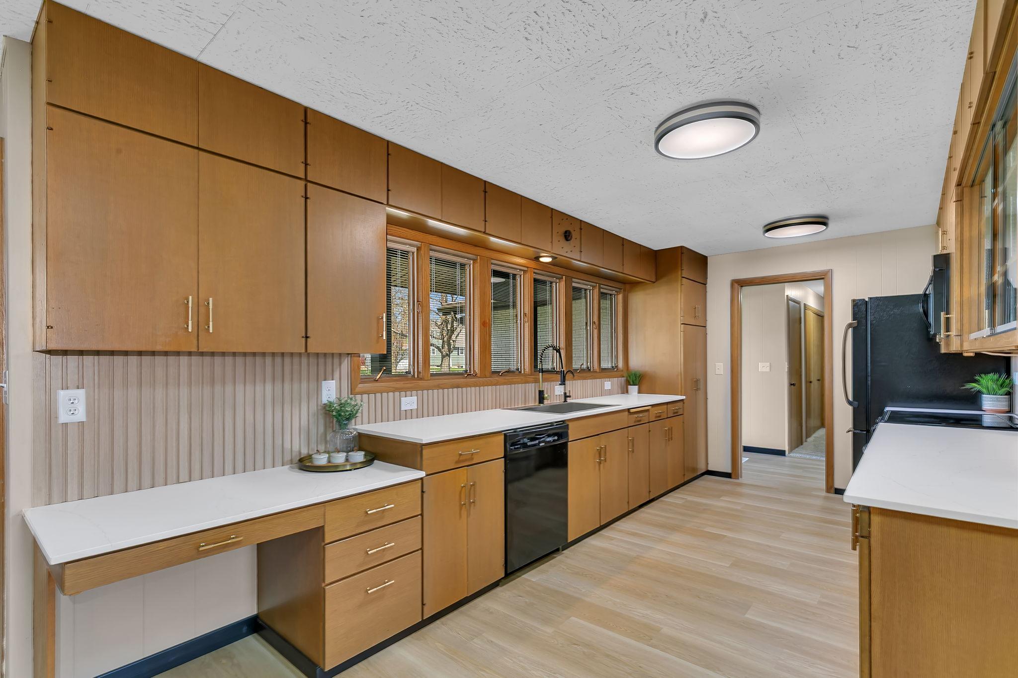 Ample cabinetry for all your culinary needs. Note the all the gold and black accents.