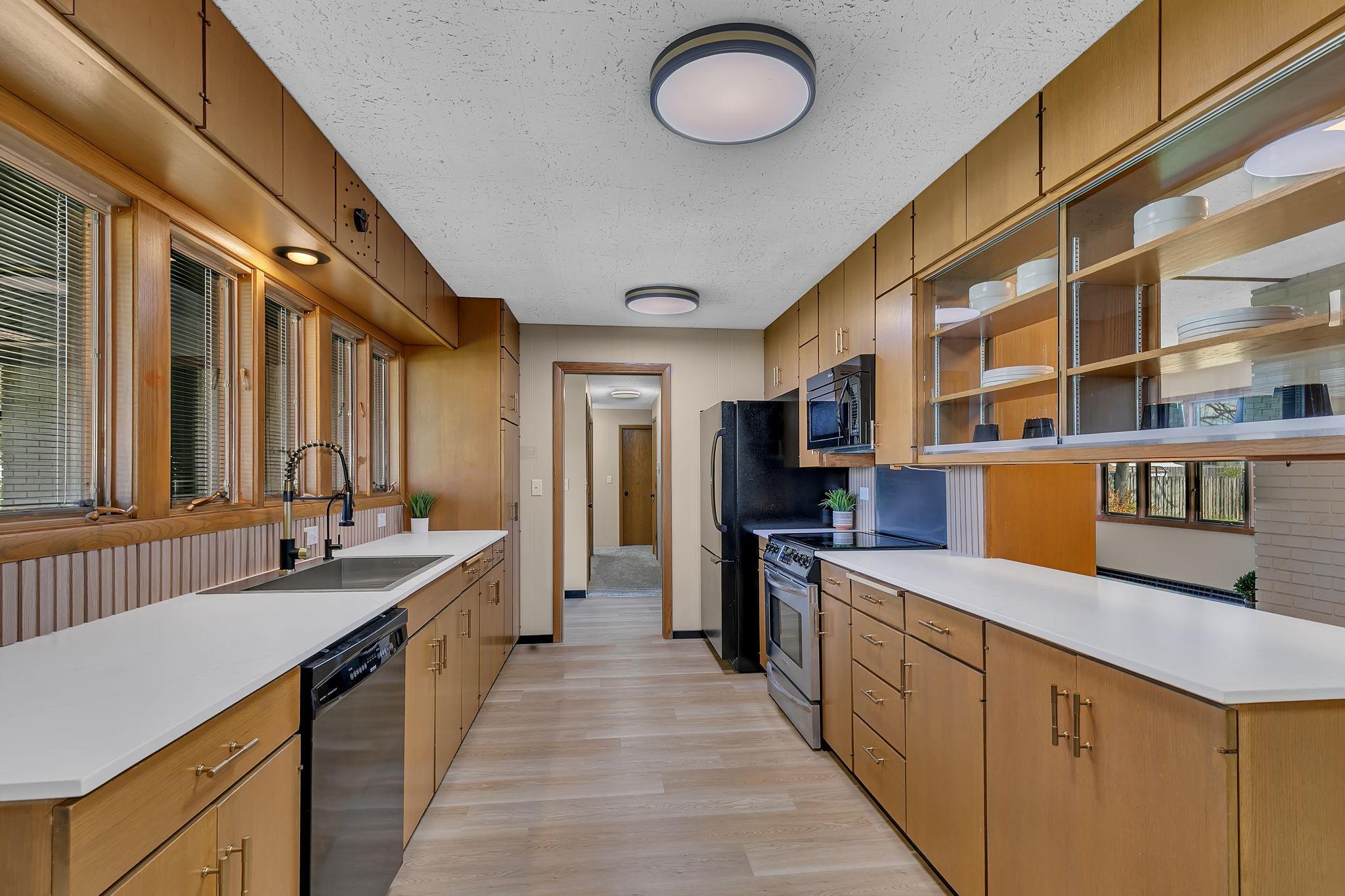 Plenty of counter top space to prep all your meals. Stone counters perfectly accent the warm wood tones.