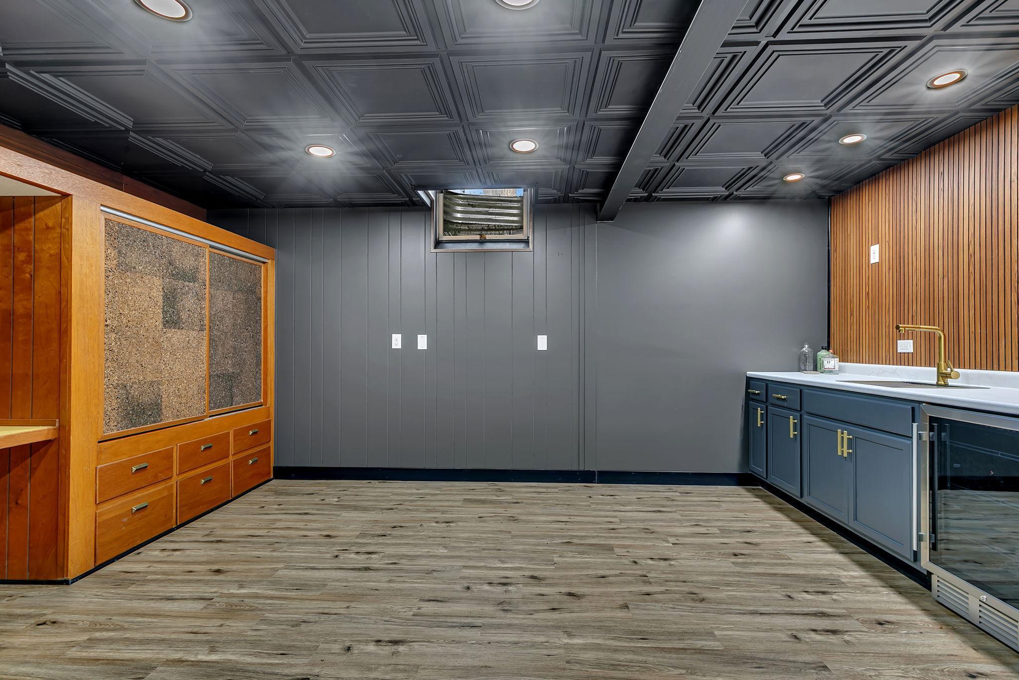 A speak easy man cave vibe with a galley bar- this room would be great with a pub table or your favorite gaming set up.