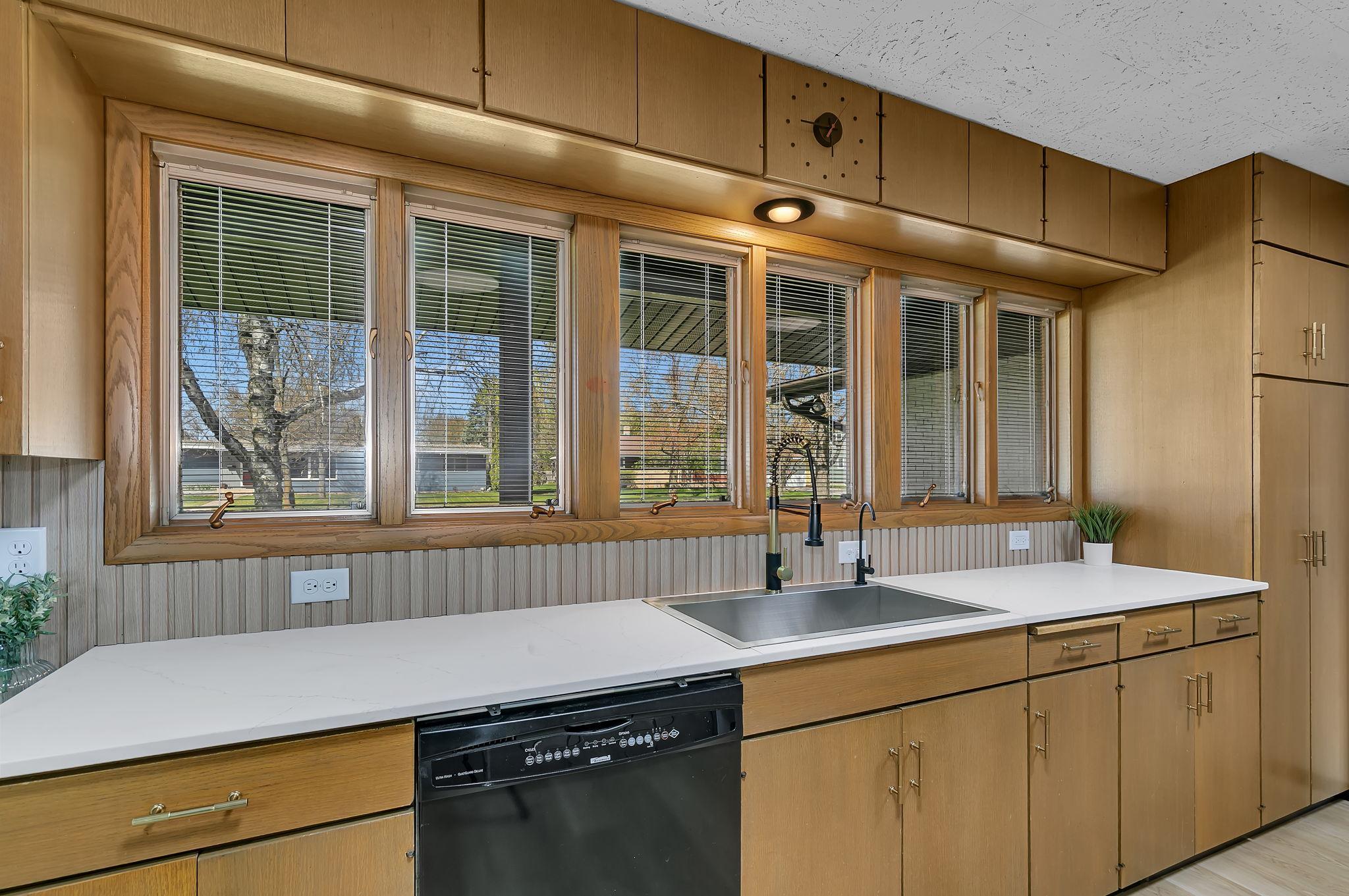 Kitchen features several windows, creating a bright and inviting atmosphere.