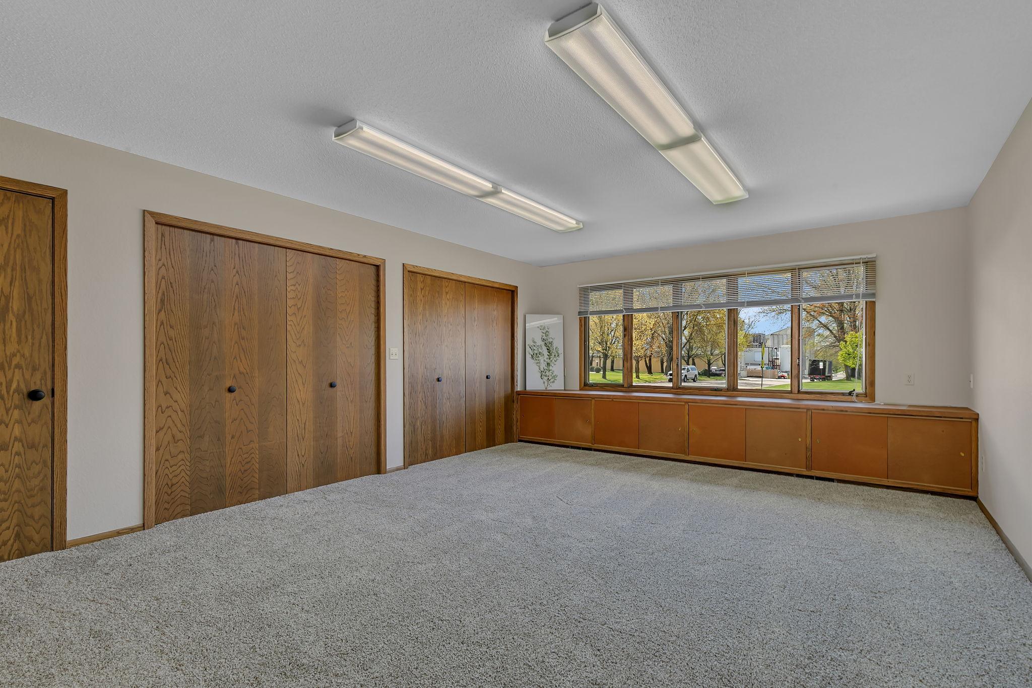 Large primary bedroom, ready for your personal touches. This room with tons of closet and storage was used previously as an art studio. Don't need 4 bedrooms? Room could be a den or office.