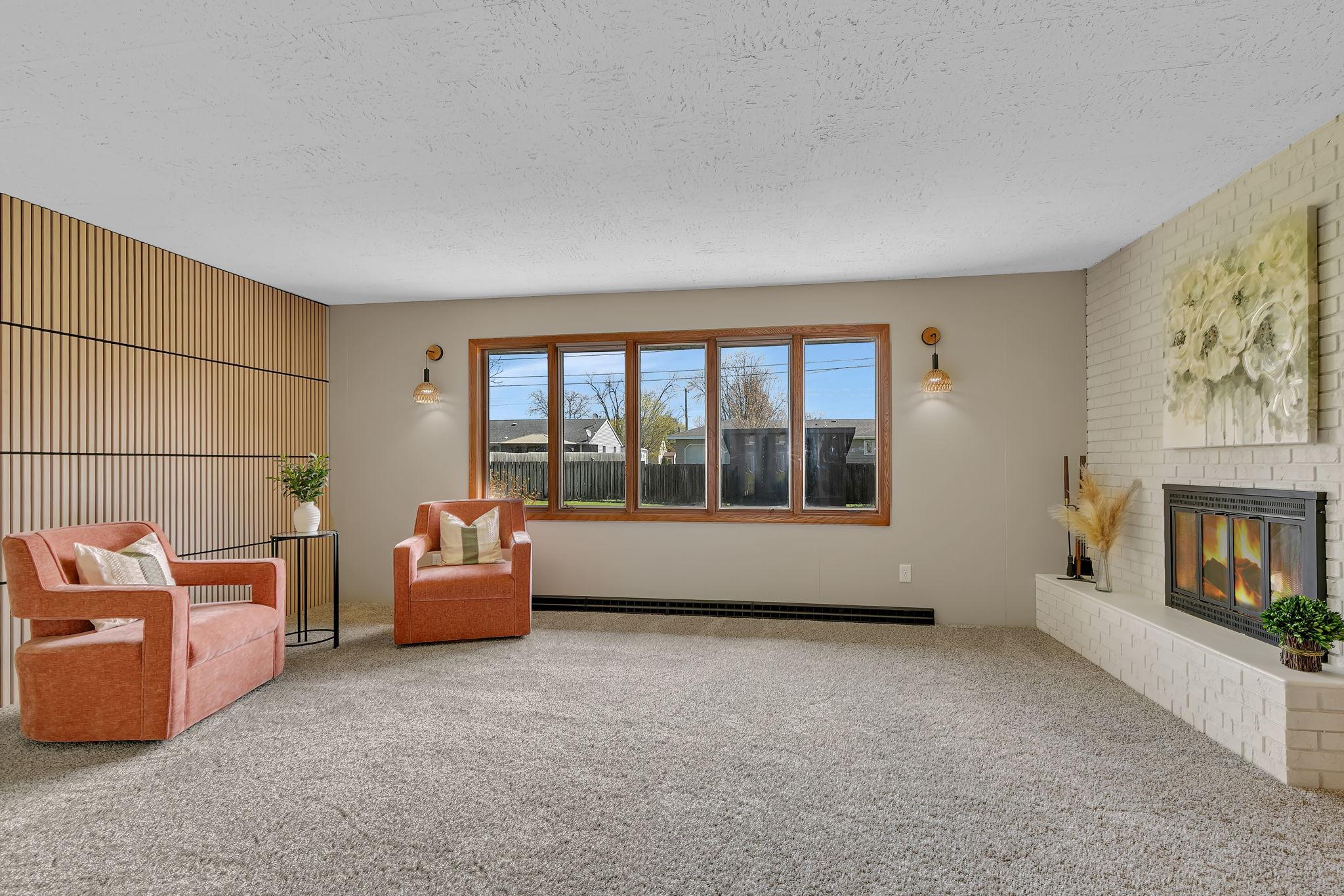 Bright front living room provides a great first impression of the home. Fireplace is gorgeous, and the fenced in yard is beautiful.