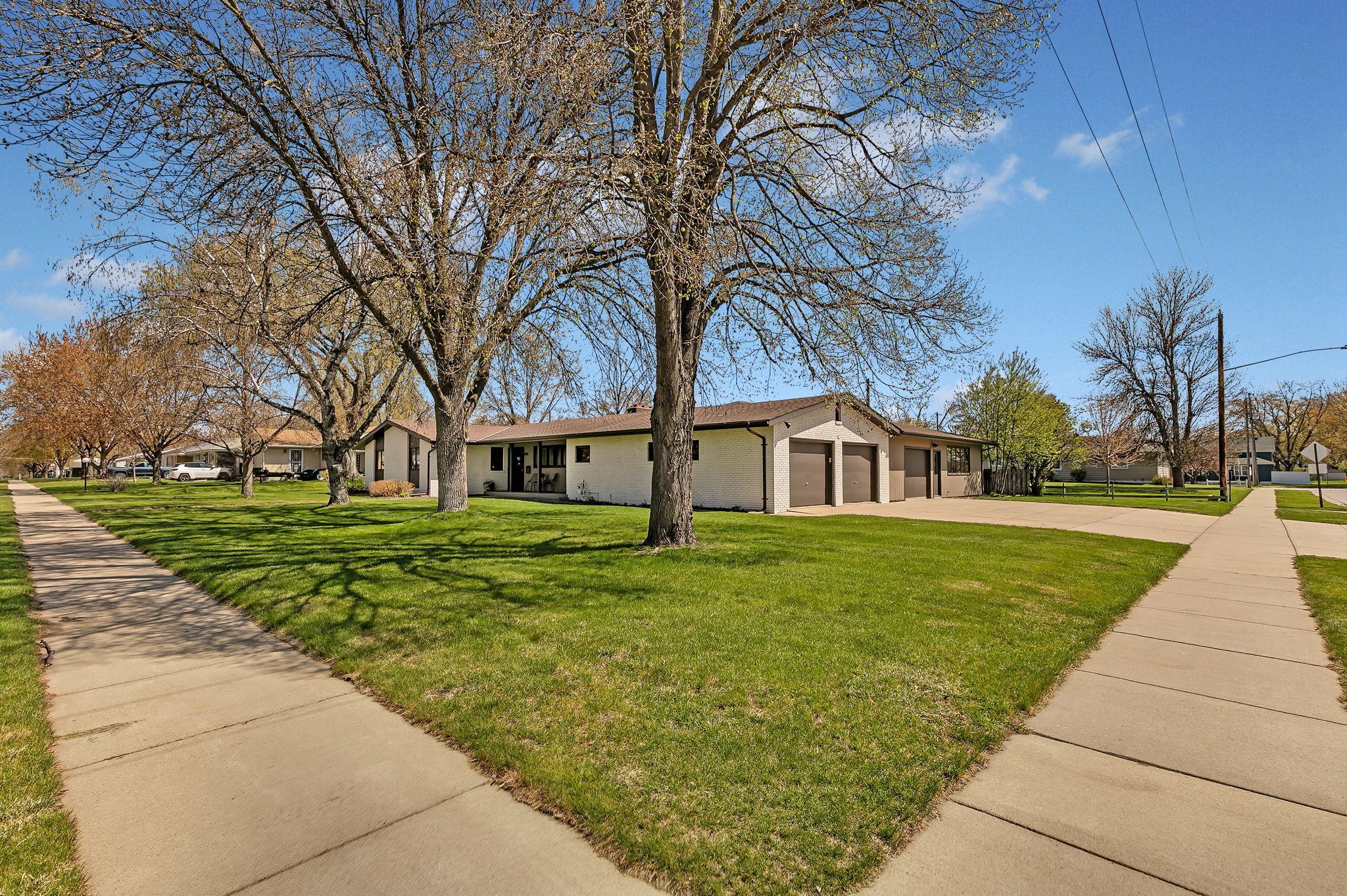 Mature trees shade the lot during the hot summer months. Corner lot with access to sidewalks. School is in walking distance.