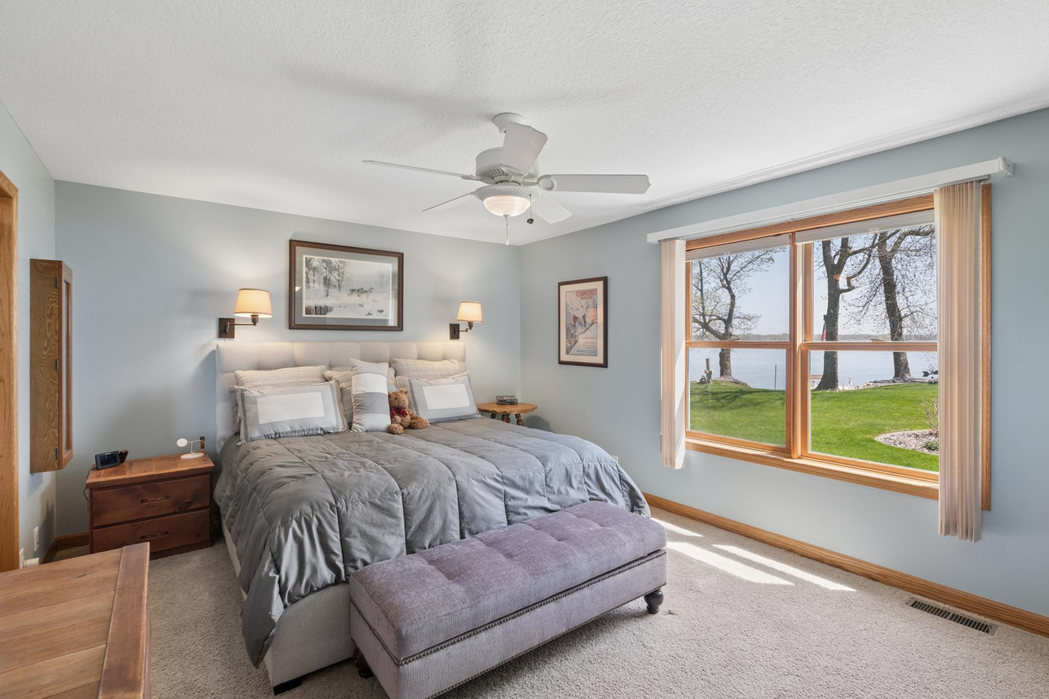 Large primary bedroom that sits on the main floor with a wonderful lake view!