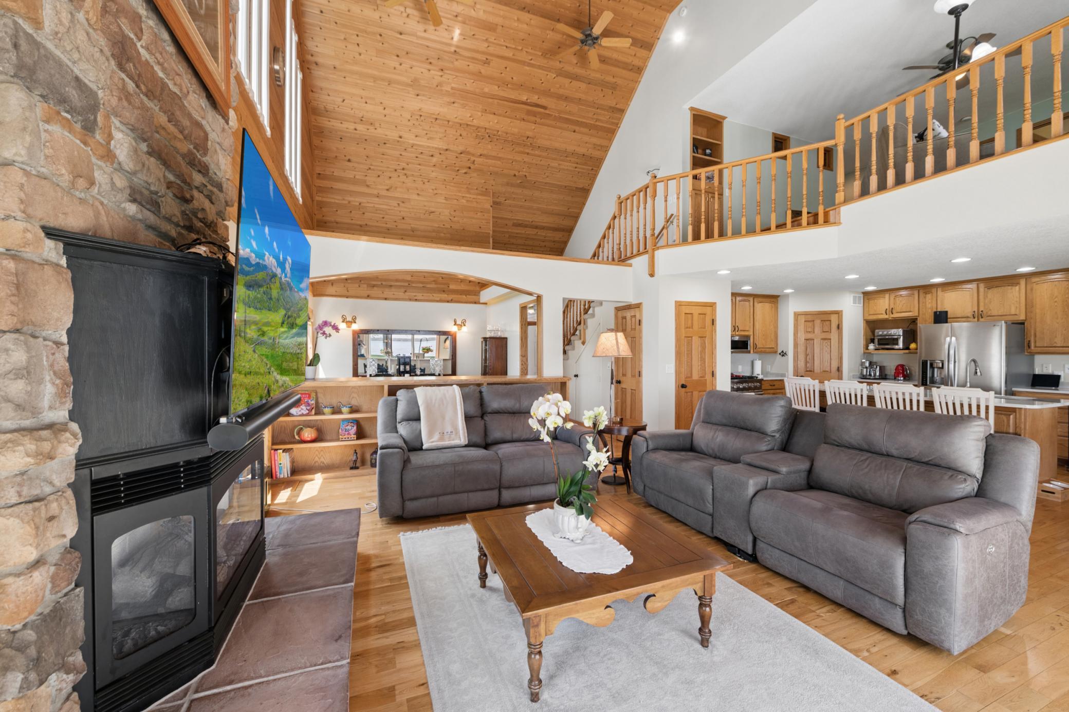Open view of the living room, kitchen with breakfast bar, and the vaults making it open to the upper level!