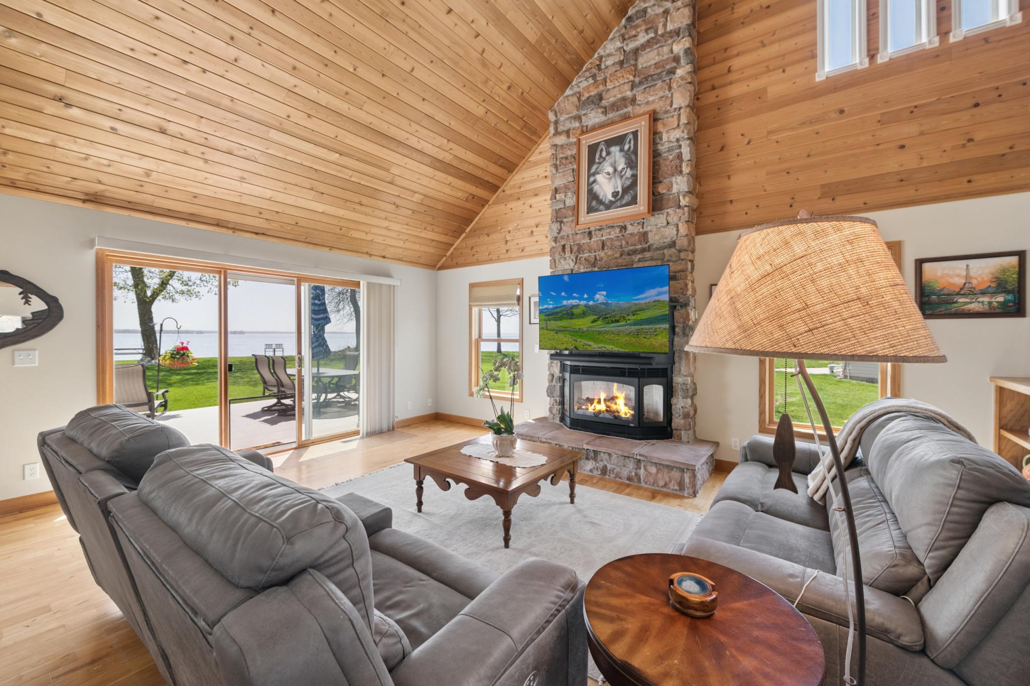 This vaulted full wall fireplace - and the VIEW looking out towards the lake! Priceless!