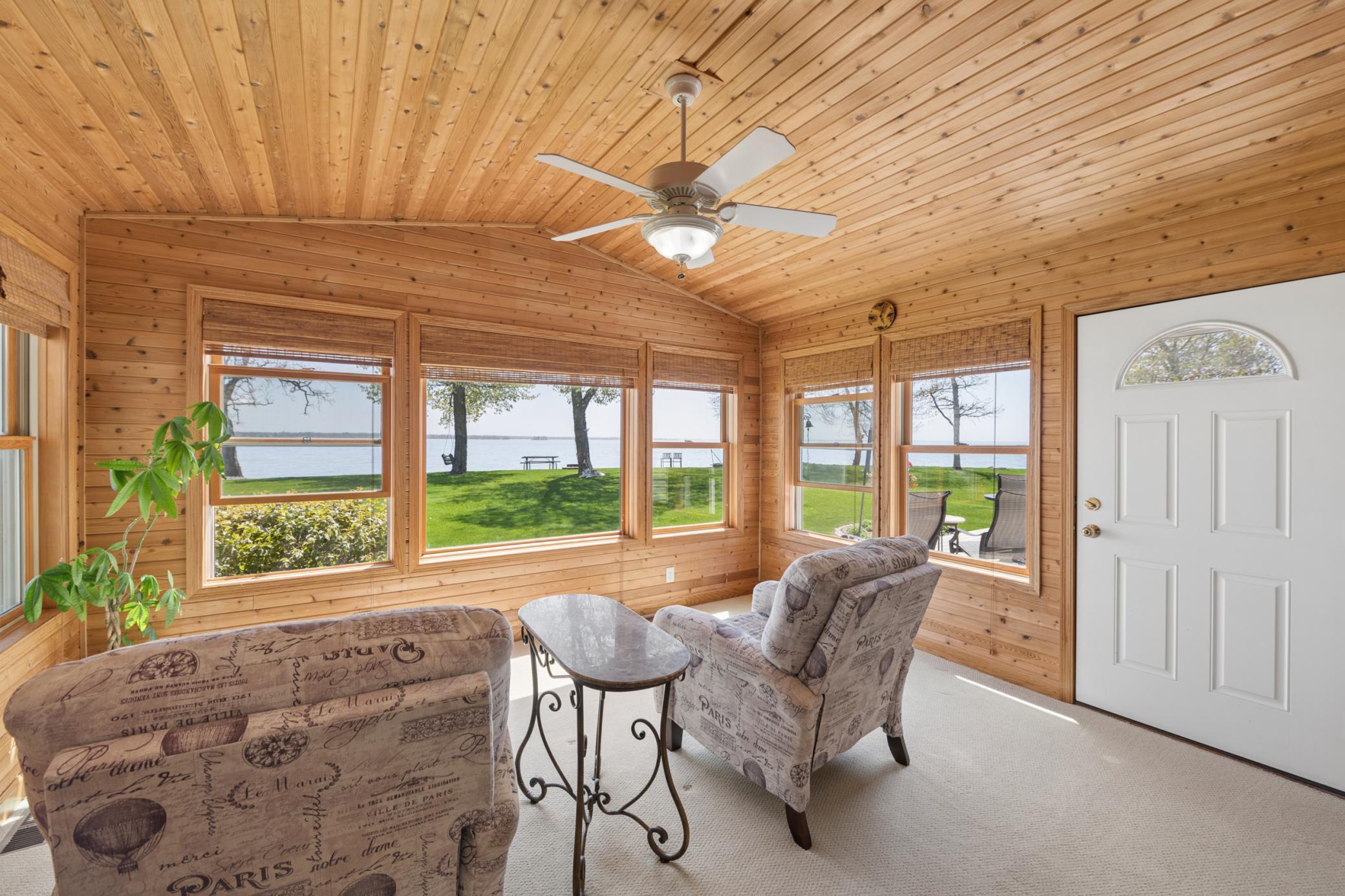 Main floor sunroom - overlooking the lake and walking out to the deck! All the views!