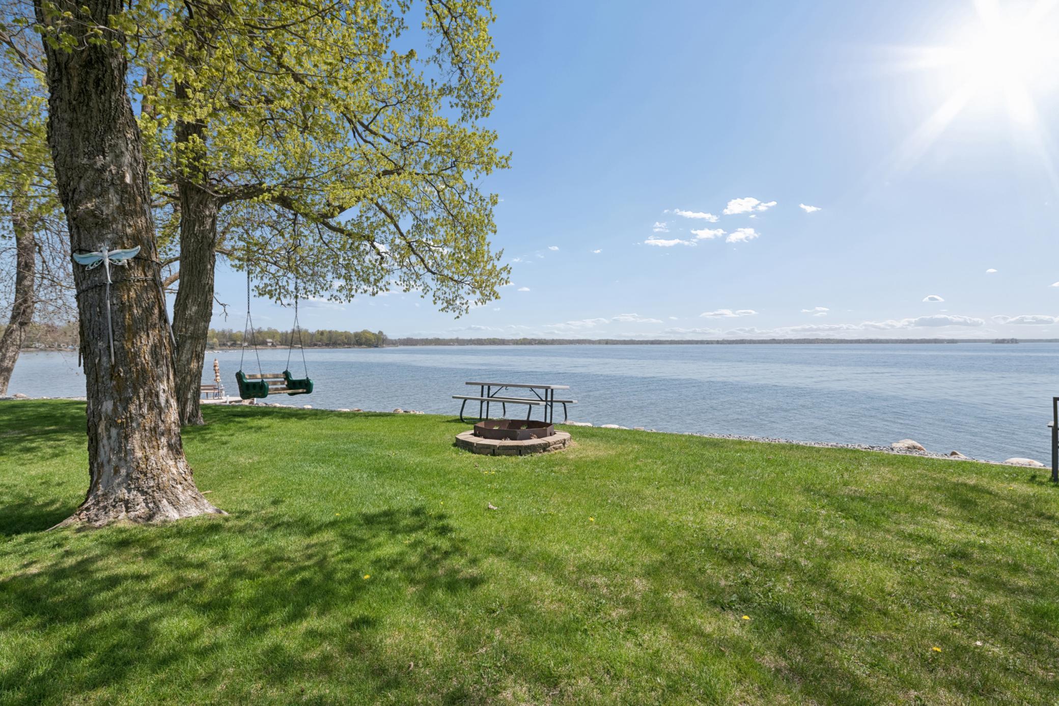 Firepit and swing overlooking the lake corner...