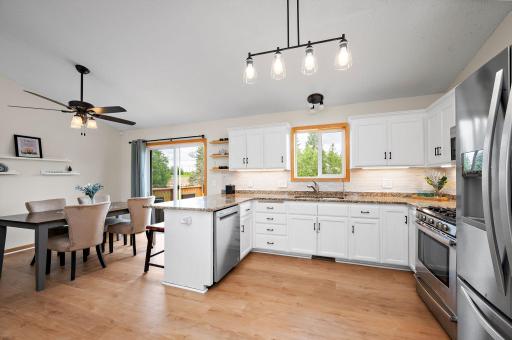 Boasting a bright, open floor plan with dramatic vaulted ceilings, the home features beautiful new flooring throughout