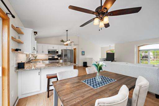 Boasting a bright, open floor plan with dramatic vaulted ceilings, the home features beautiful new flooring throughout