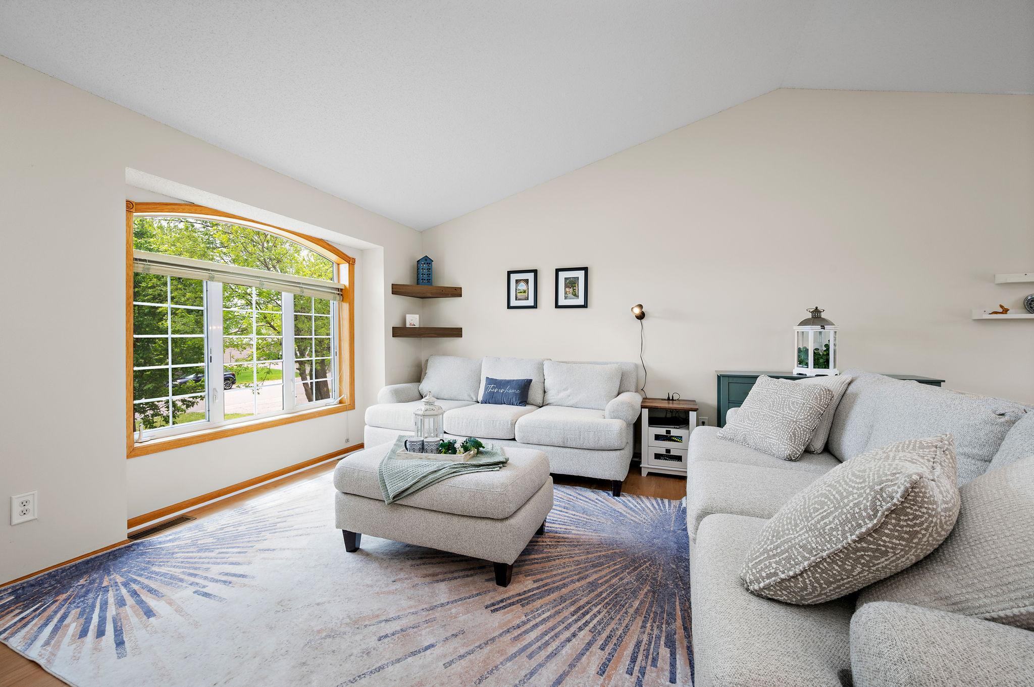 Living Room with open floor plan with dramatic vaulted ceilings!