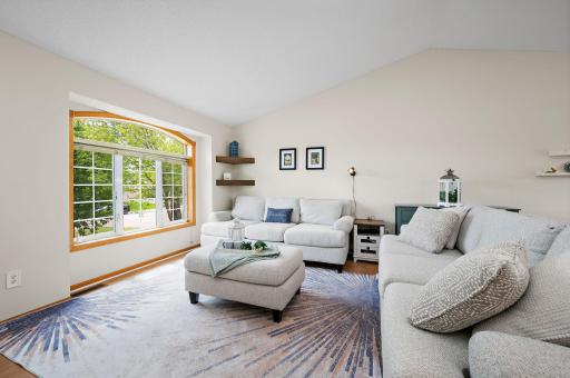 Living Room with open floor plan with dramatic vaulted ceilings!