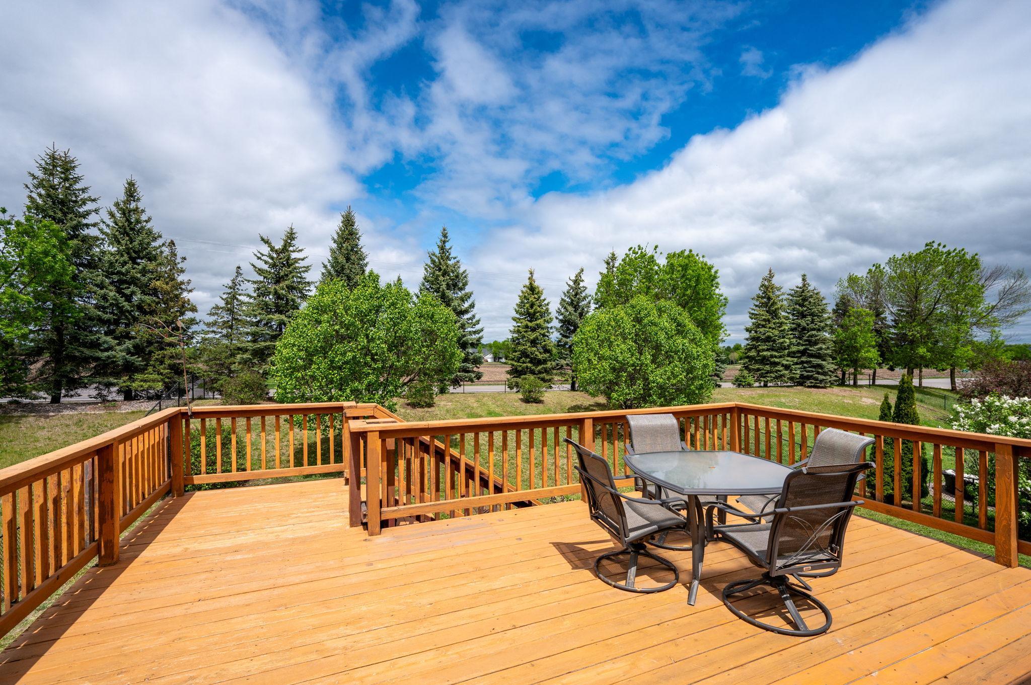 Nice deck featuring stairs that lead down to a fully fenced, private backyard—complete with a gate that opens directly to a peaceful walking path!