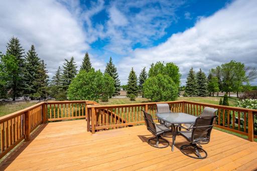 Nice deck featuring stairs that lead down to a fully fenced, private backyard—complete with a gate that opens directly to a peaceful walking path!