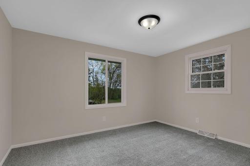Upper level bedroom with plush carpeting.