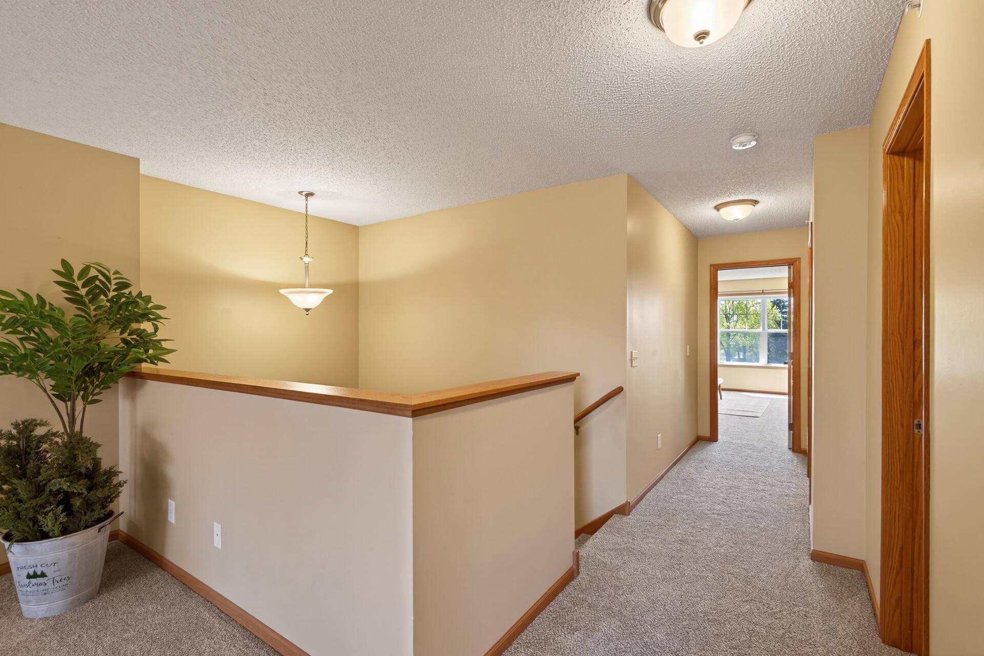 Hallway looking toward Primary Bedroom and large Laundry/Utility room