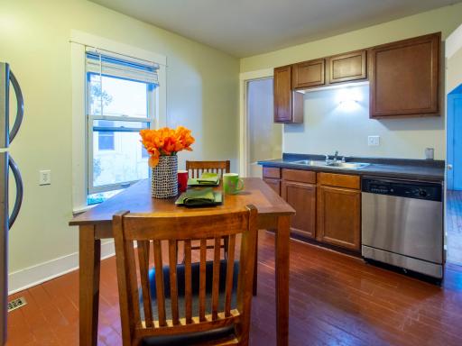 Alternate view of kitchen, showing doorway to the stairs to the upper level.