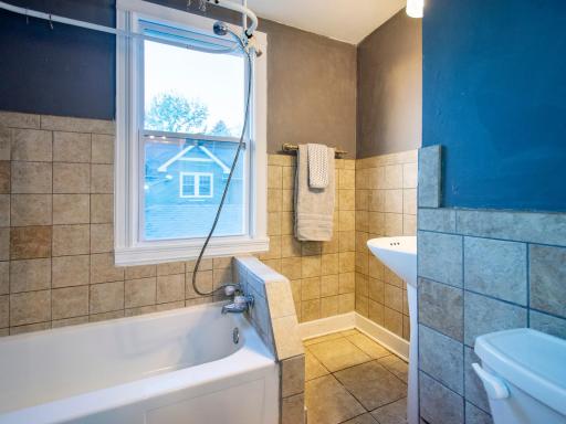 Between the two upper bedrooms is the full bath.