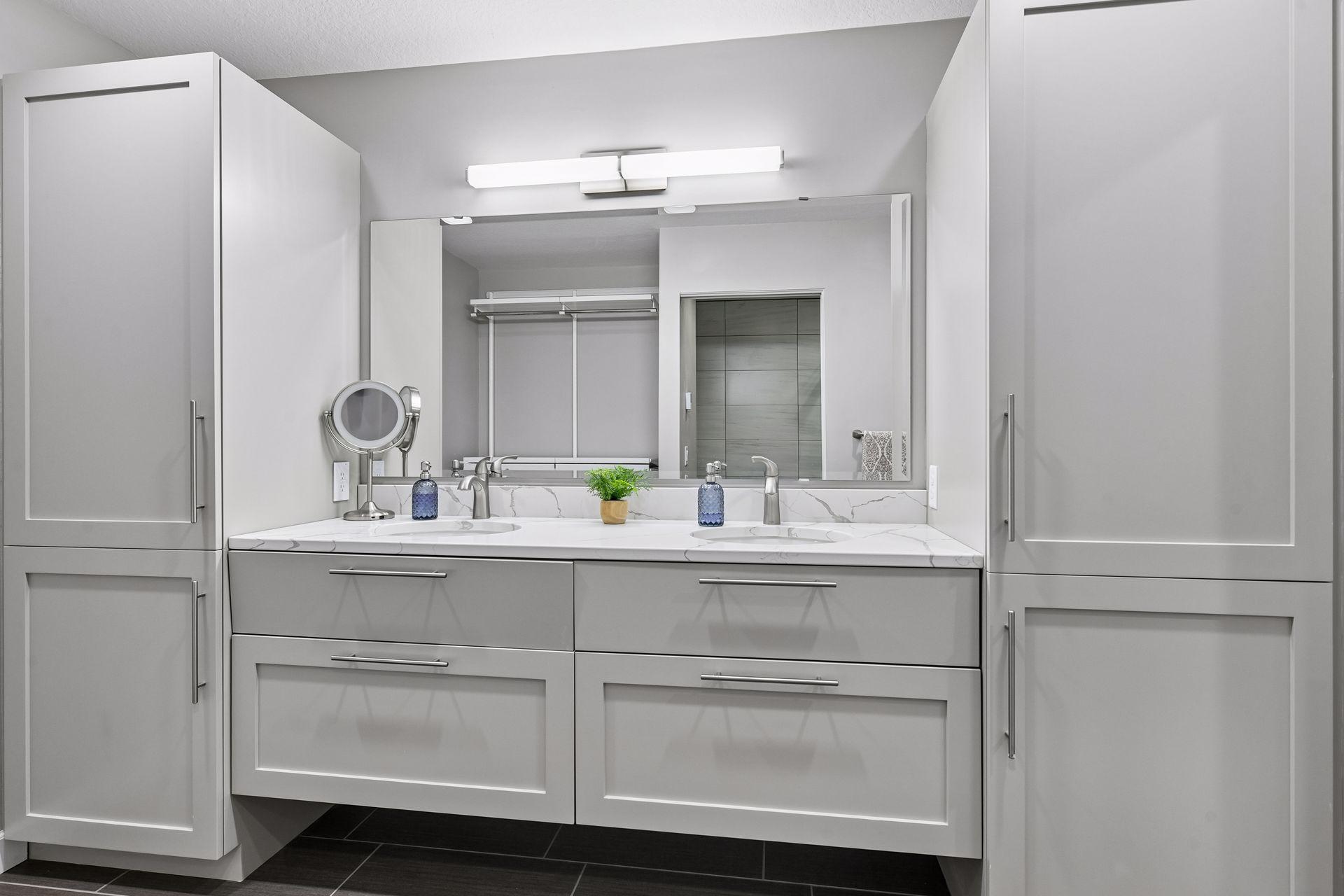 Gorgeous en-suite bath offering a floating vanity with dual sinks & storage.