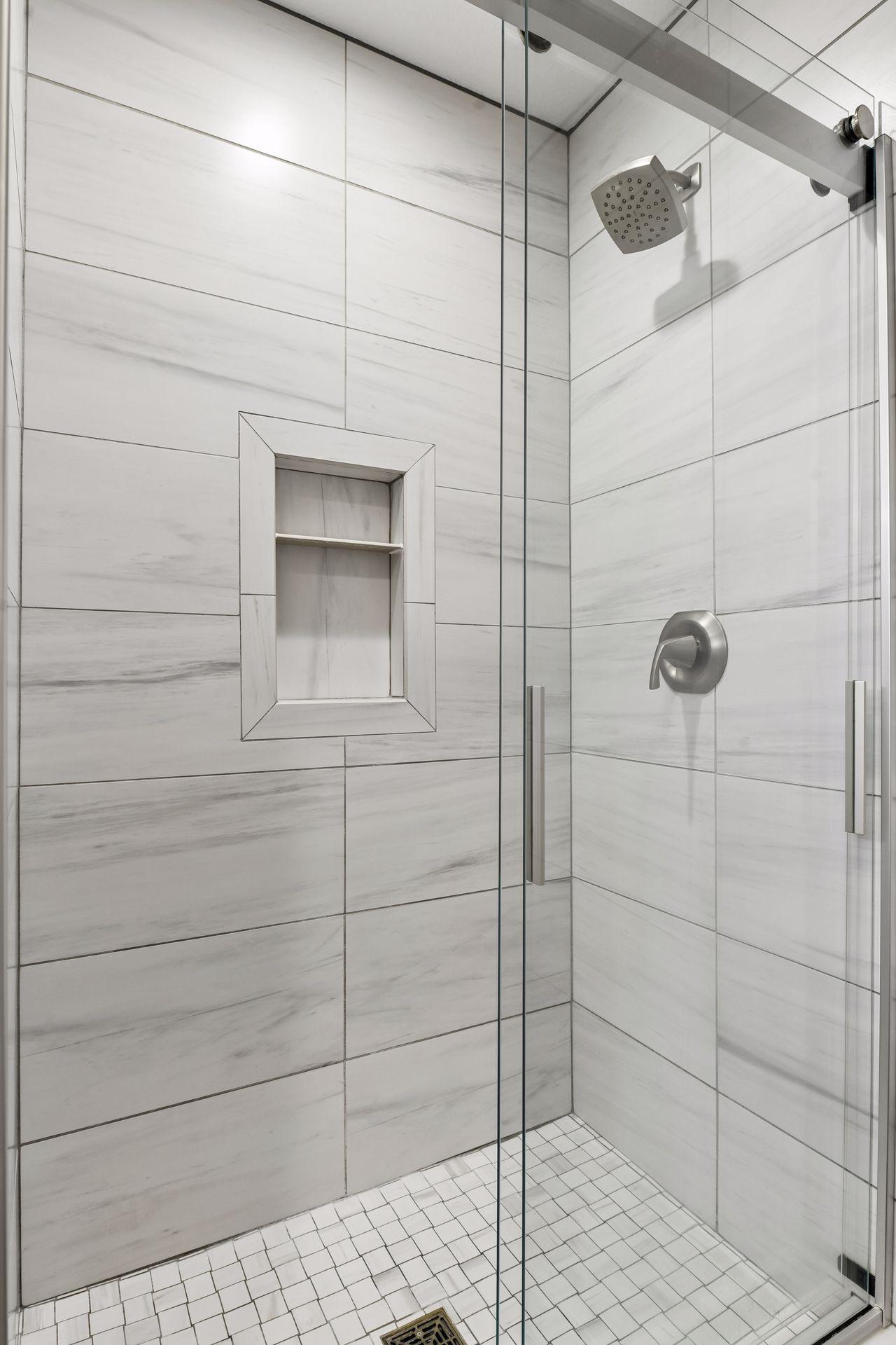 Large walk-in shower with tile surround.