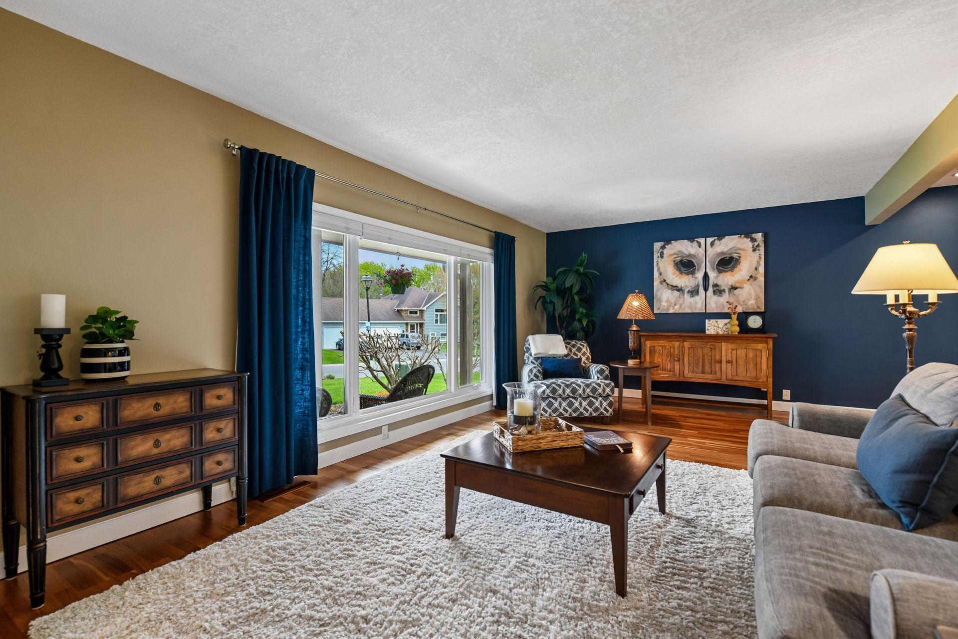 Spacious living room anchored by a large picture window.