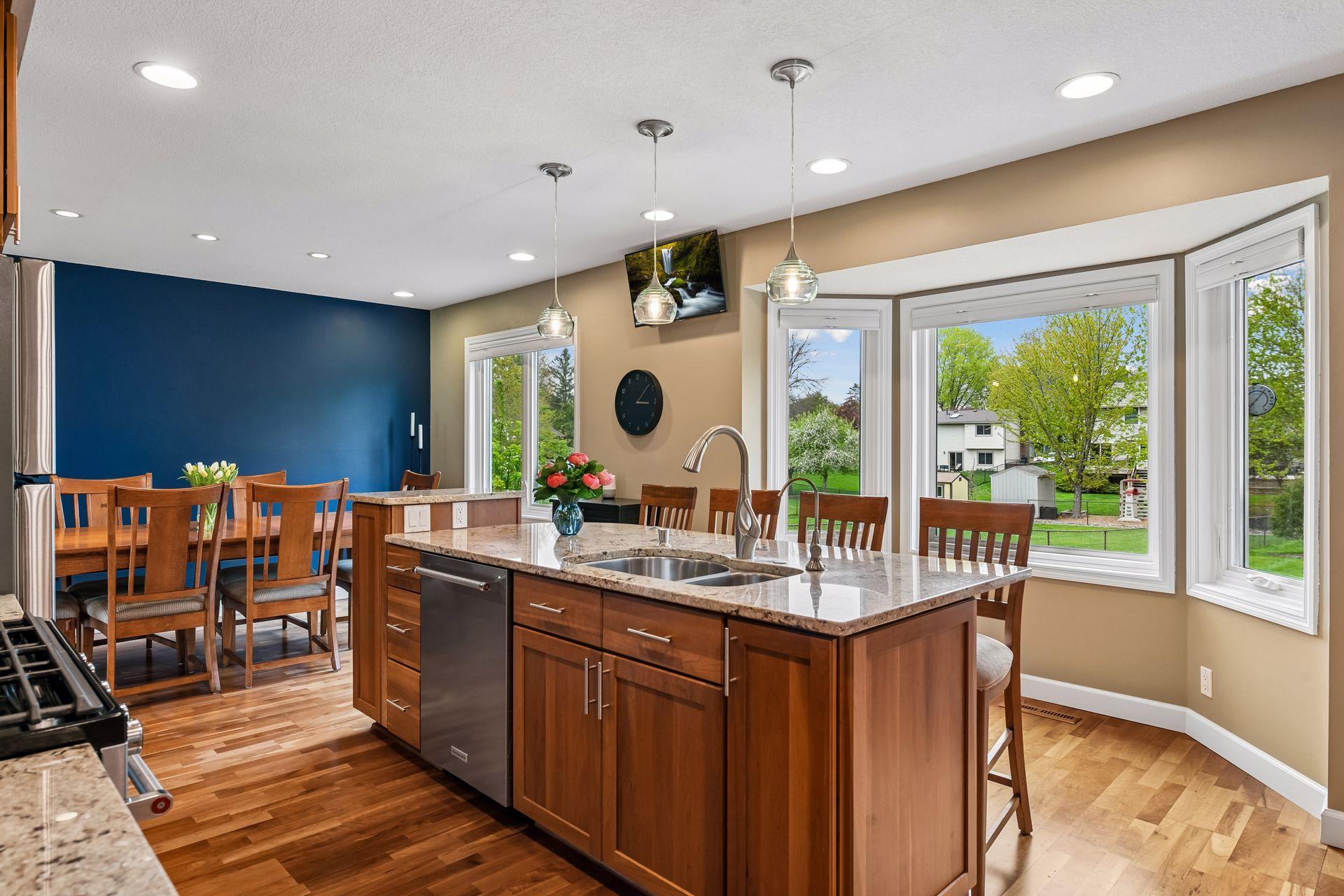 Large center island with seating and a window view of back yard