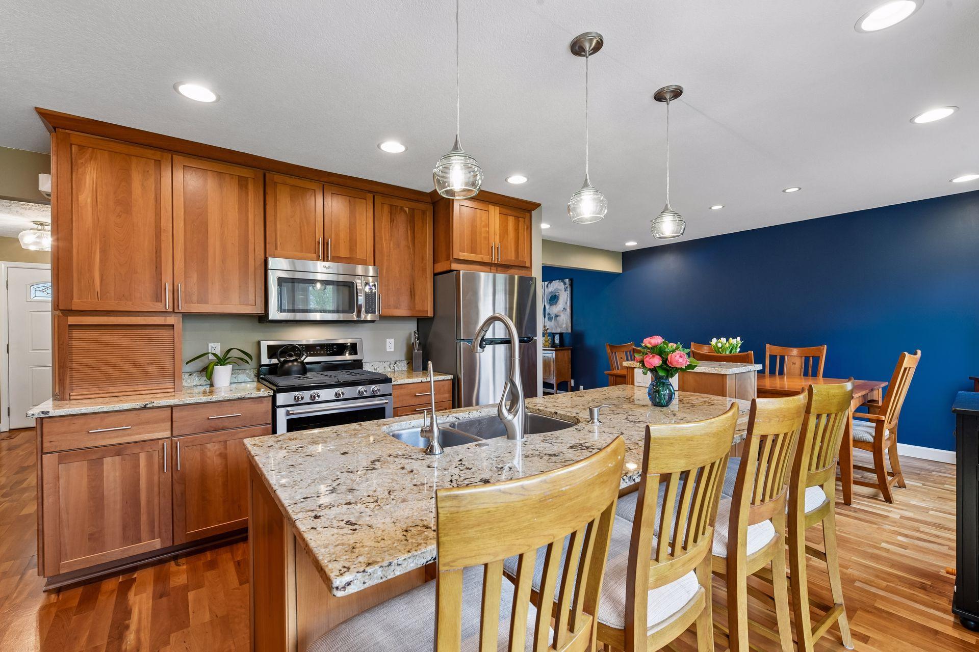 The kitchen features natural cherry cabinetry, granite countertops, stainless steel appliances.