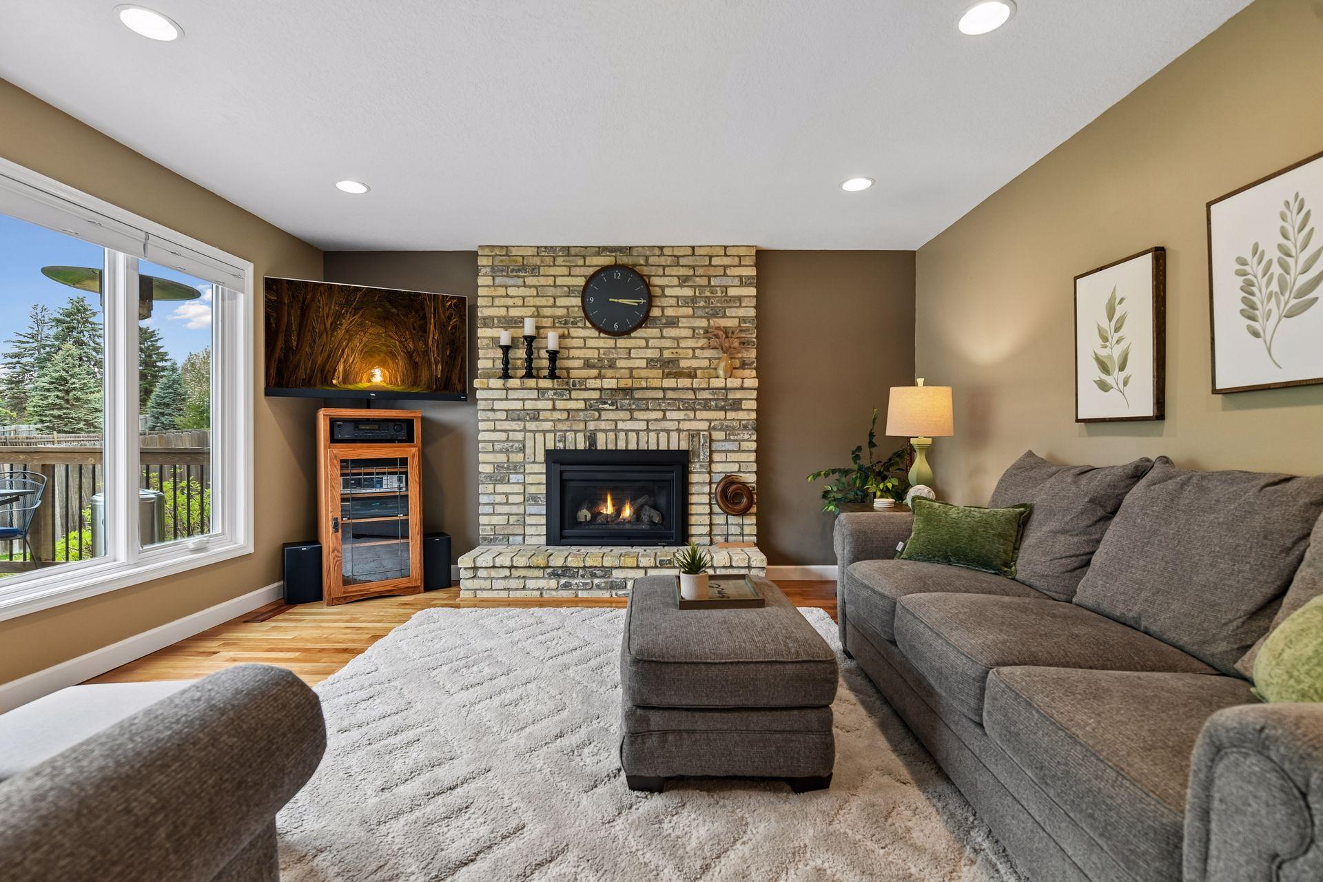 Family room features a gas fireplace with floor-to-ceiling brick surround.