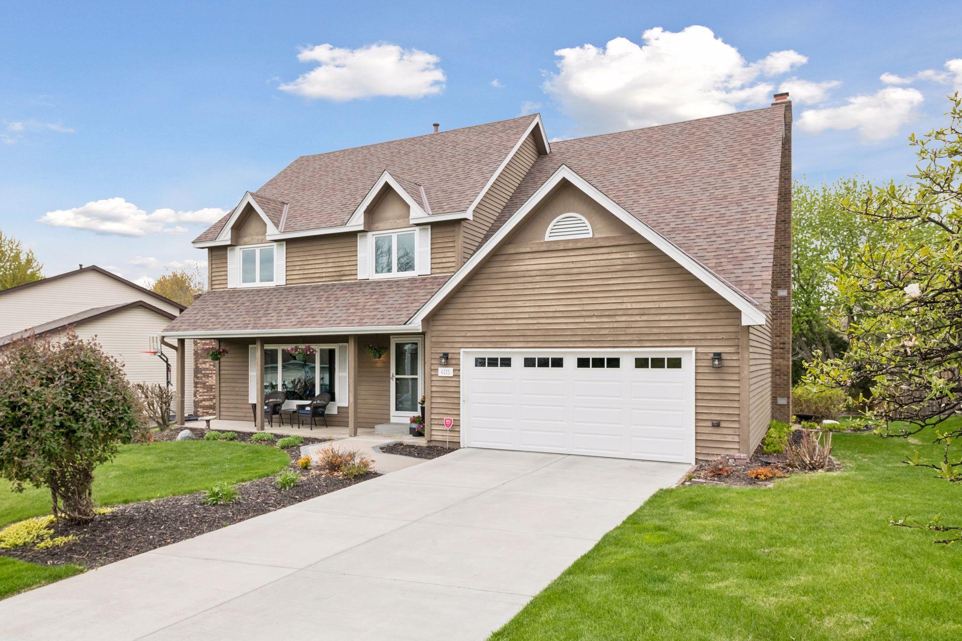 Fabulous curb appeal with a concrete driveway.