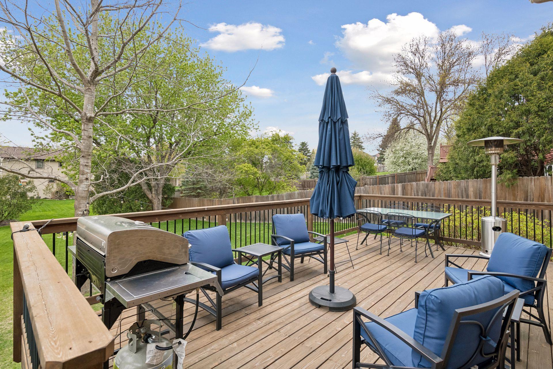 Large deck overlooks the backyard, ideal for entertaining or relaxing.