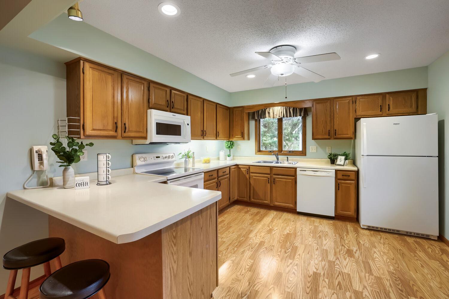 Eat-in kitchen with laminate flooring.