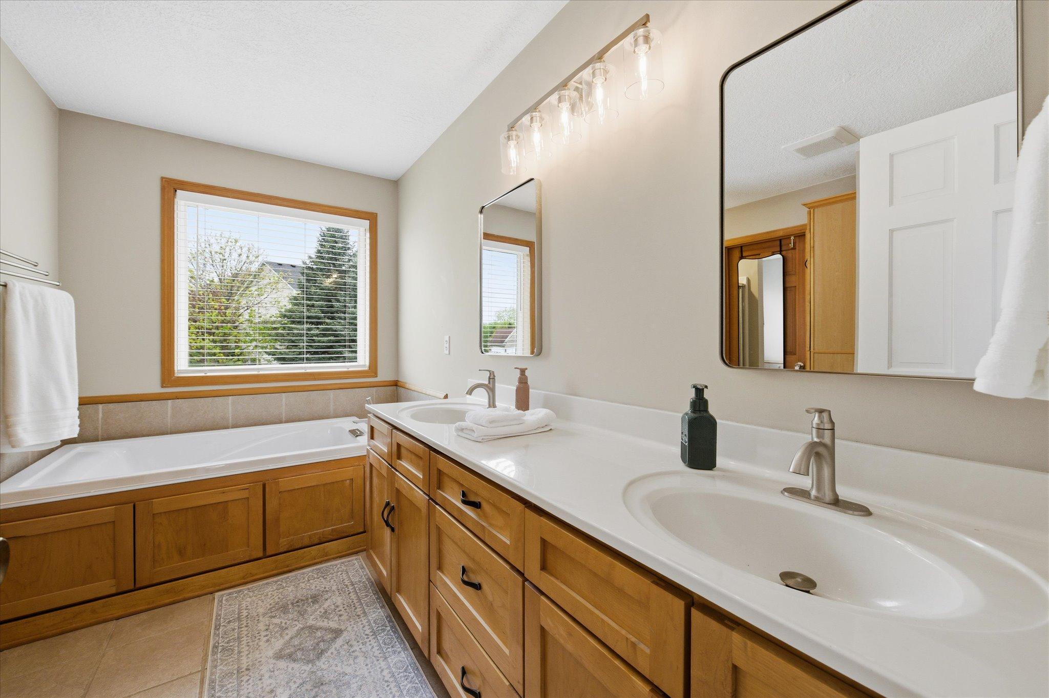 Double vanity, soaking tub, separate shower and walk-in closet in the primary suite
