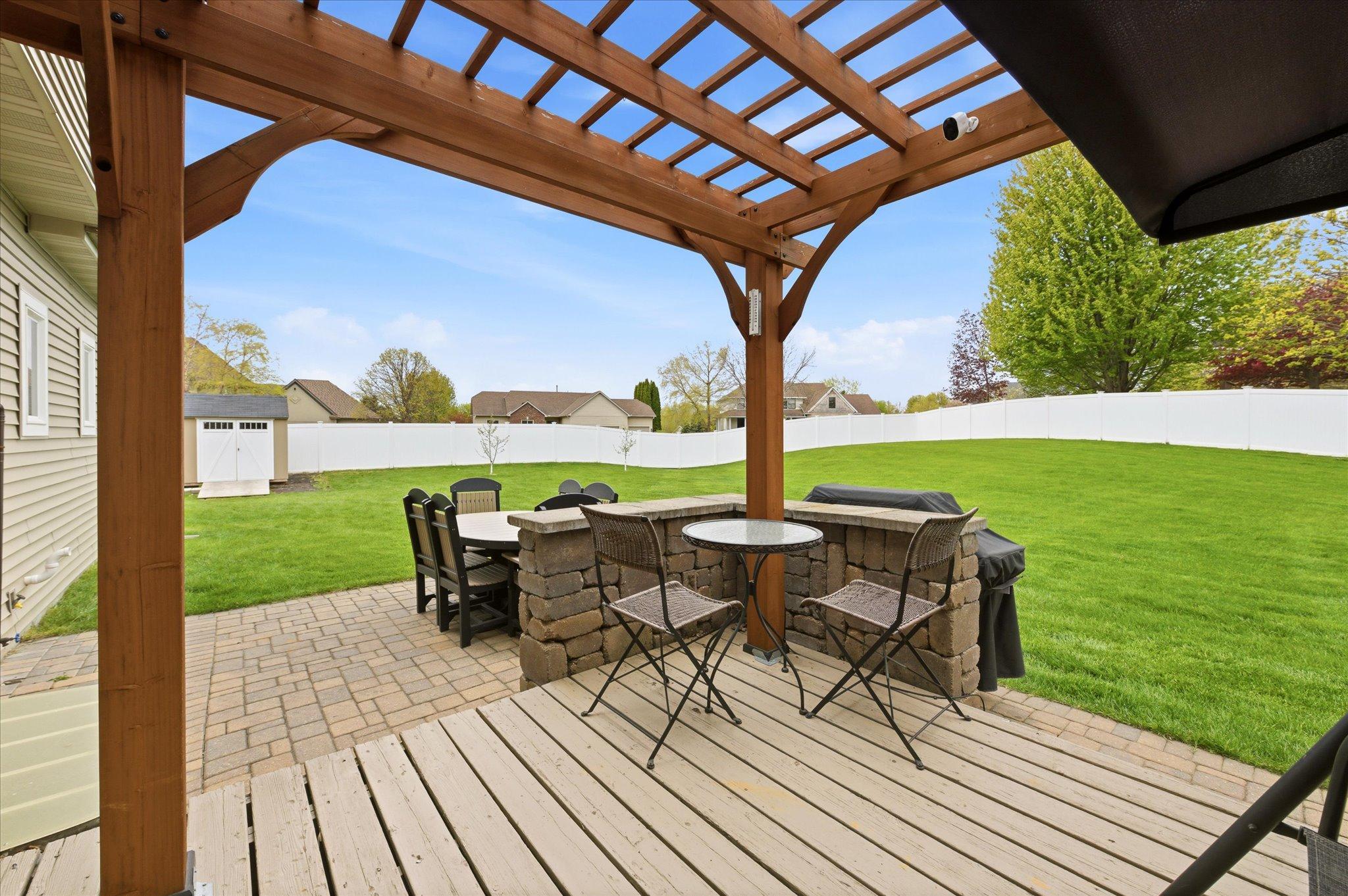 From the kitchen step out to the pergola covered deck and paver patio