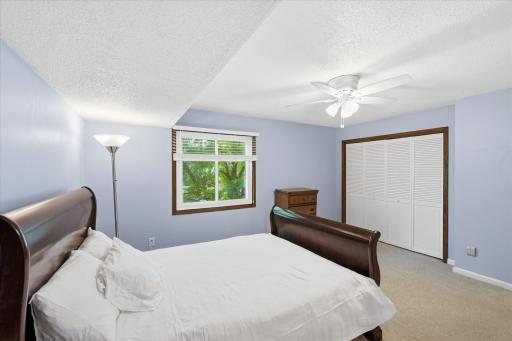 Upper-level primary bedroom with double door closet and walk-in closet