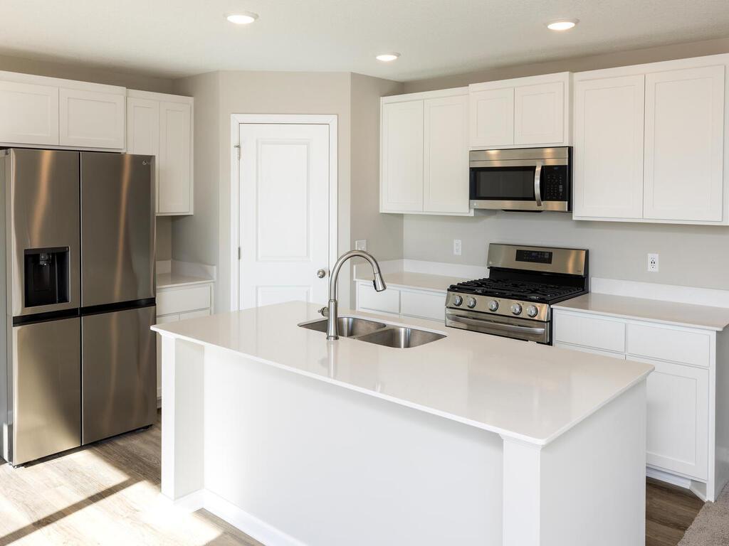 Photo taken of another home with similar plan and finishes. Photos and renderings may not depict actual plan, materials, & finishes may vary. All measurements are approximate.
