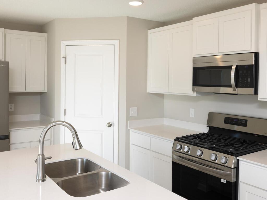 Photo taken of another home with similar plan and finishes. Photos and renderings may not depict actual plan, materials, & finishes may vary. All measurements are approximate.
