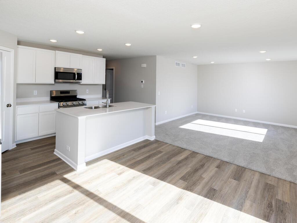 Photo taken of another home with similar plan and finishes. Photos and renderings may not depict actual plan, materials, & finishes may vary. All measurements are approximate.