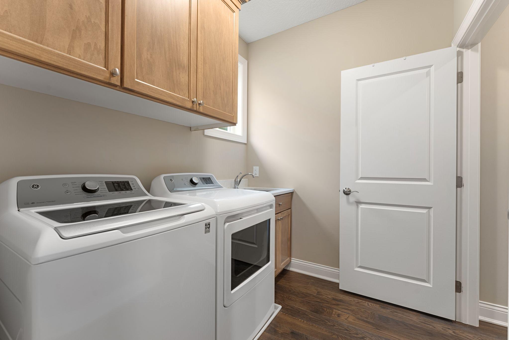 YES -- SO BRILLIANT! The main-floor laundry is located off of the primary suite. Just unload and step into the closet to put things away... make laundry day FUN!