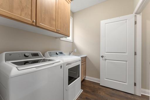 YES -- SO BRILLIANT! The main-floor laundry is located off of the primary suite. Just unload and step into the closet to put things away... make laundry day FUN!