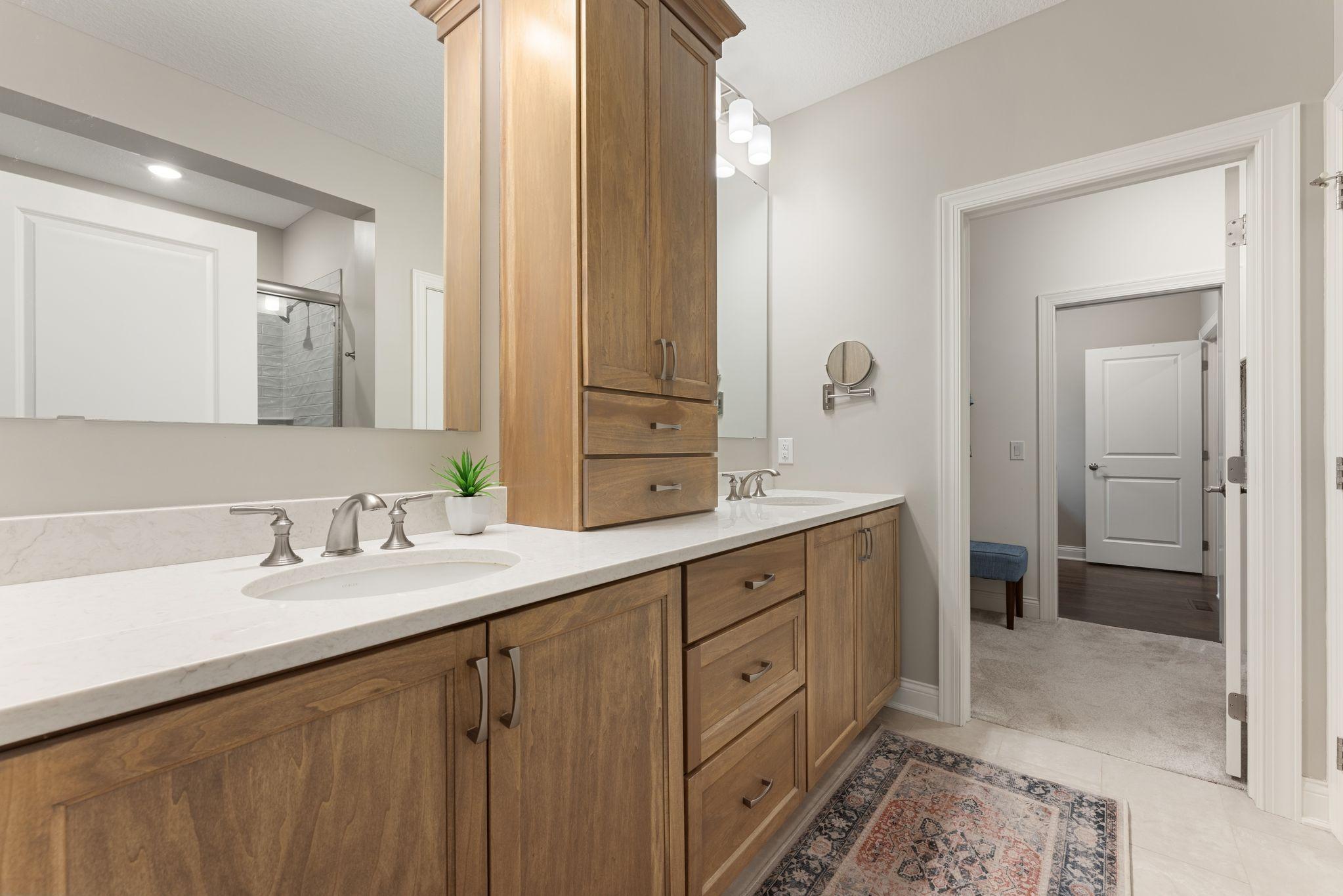 The bathroom flows seamlessly into the large, walk-in closet - equipped with a closet system.