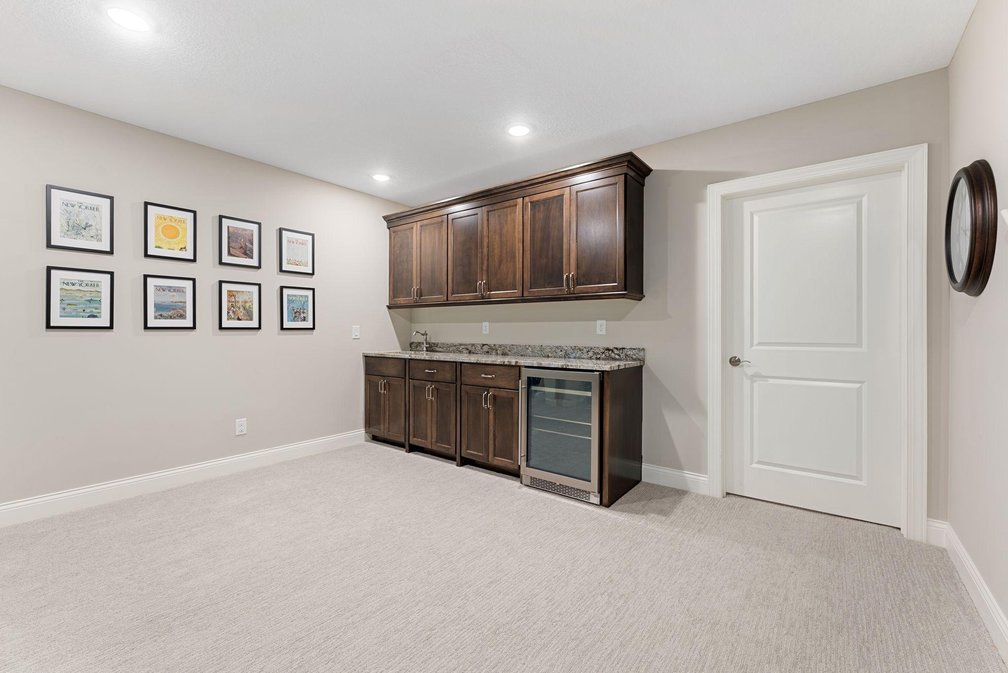 Upgraded cabinetry for this wonderful wet-bar. *The door you see is to the HUGE (22'x16') storage room!