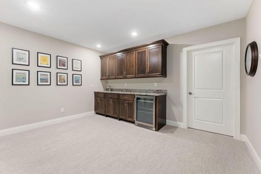 Upgraded cabinetry for this wonderful wet-bar. *The door you see is to the HUGE (22'x16') storage room!