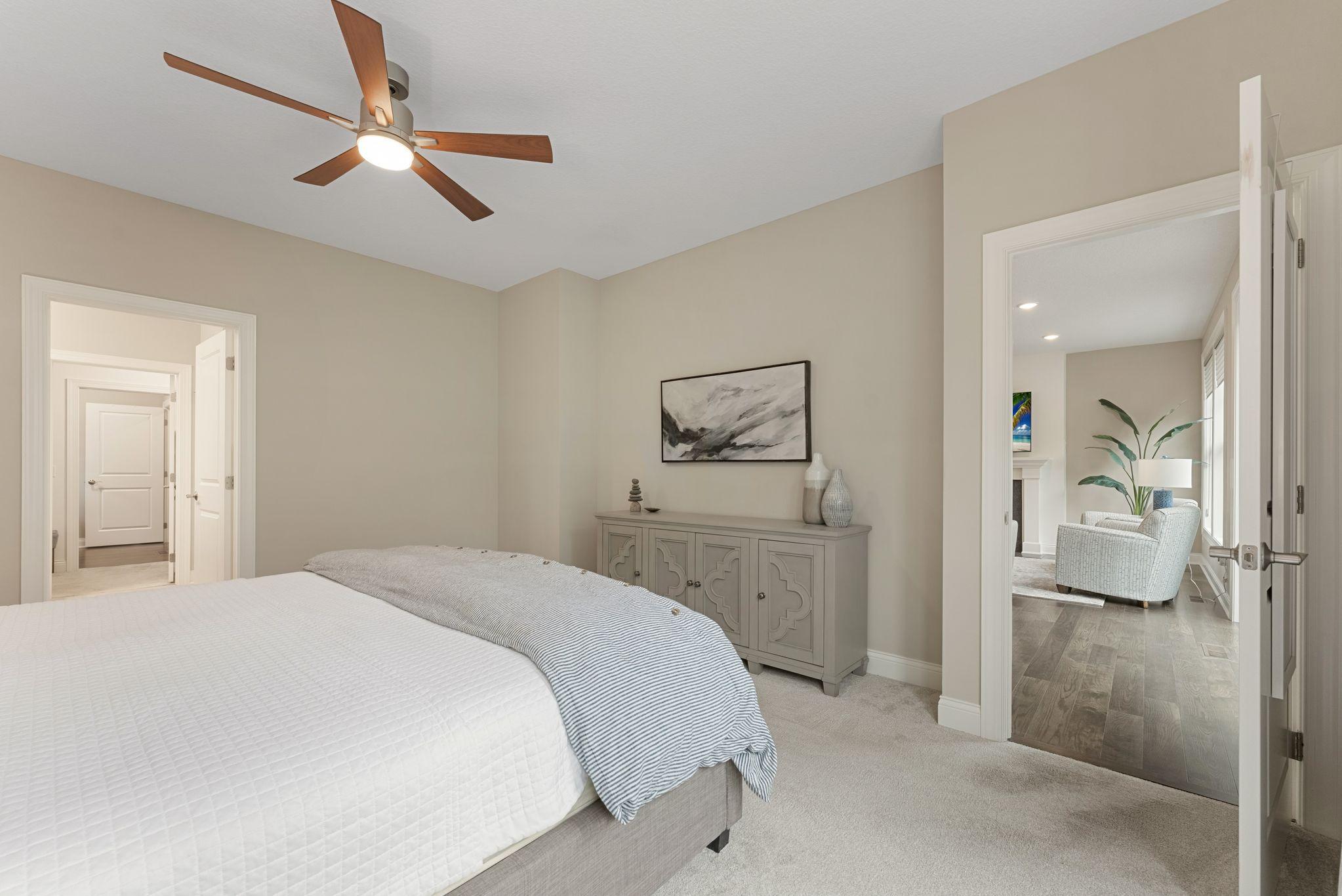 Another view of the primary bedroom suite. It's situated near the main floor living room and the slider door to access the deck.